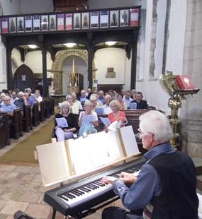 Pianist and singers in the pews